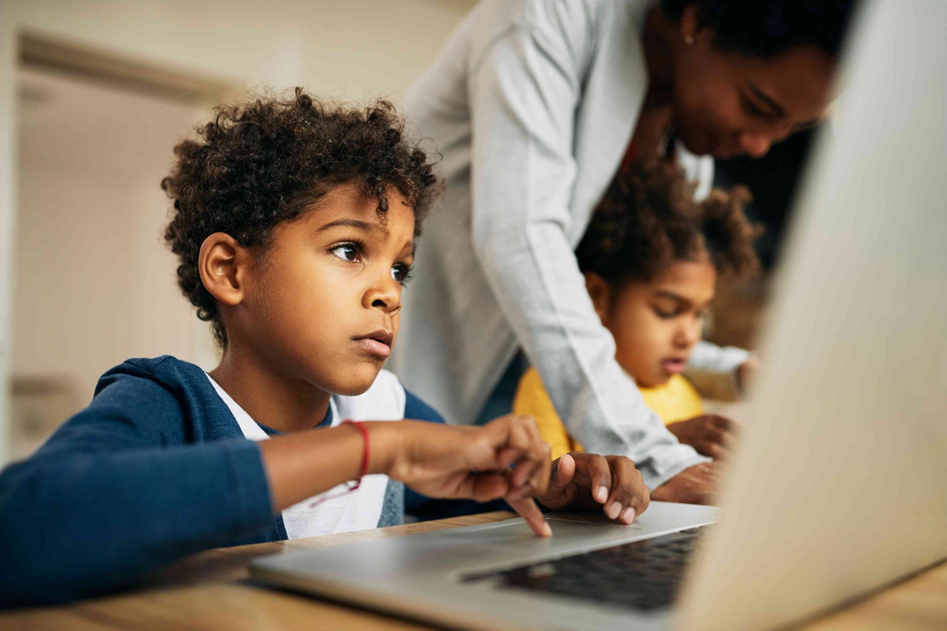 mãe com filhos no computador mostrando como usar tecnologia com segurança